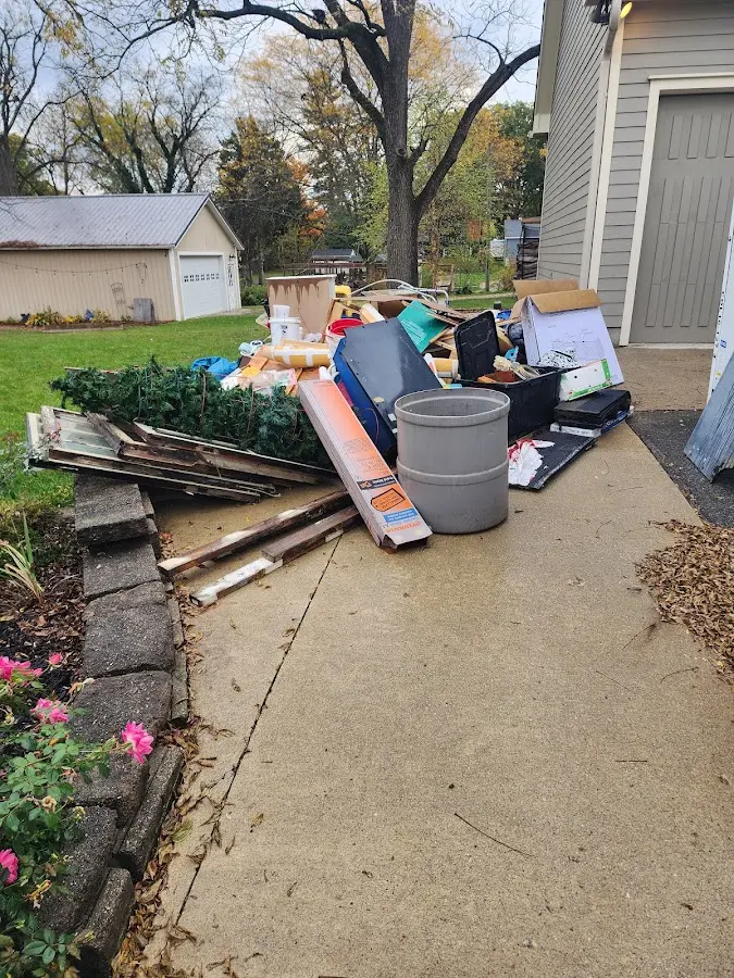 Dumpster being loaded with debris for 12 Yard Dumpster Rental in Daleville